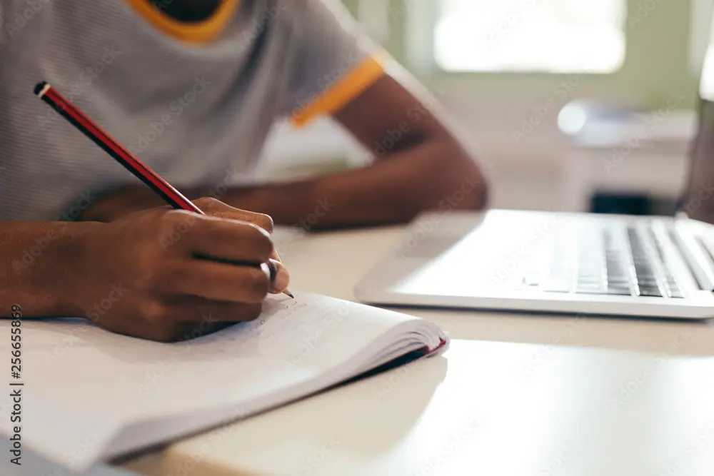 High school student writing a list